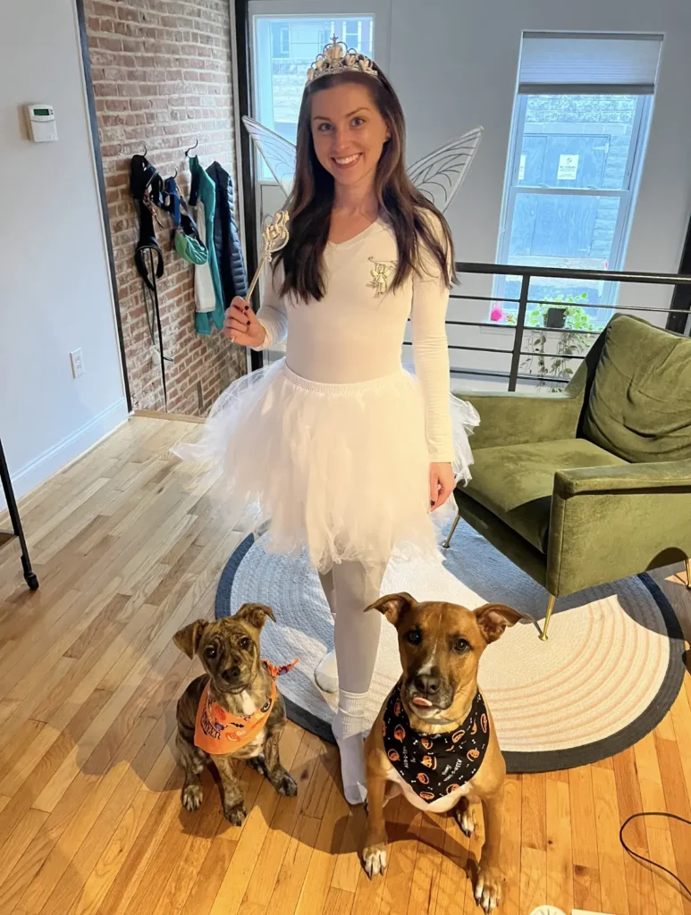 Dr. Sydney Nolan dressed up in a white costume her two dogs, Crush and Basil.