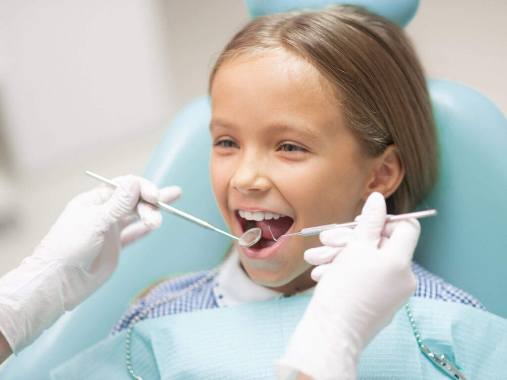 Image of a young girl getting a pediatric dentistry checkup